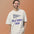 Smiling man wearing the Faded Bone moon shirt, a crew pennant with a winding lunar channel and two survey flags above the words RILLE SURVEY CREW