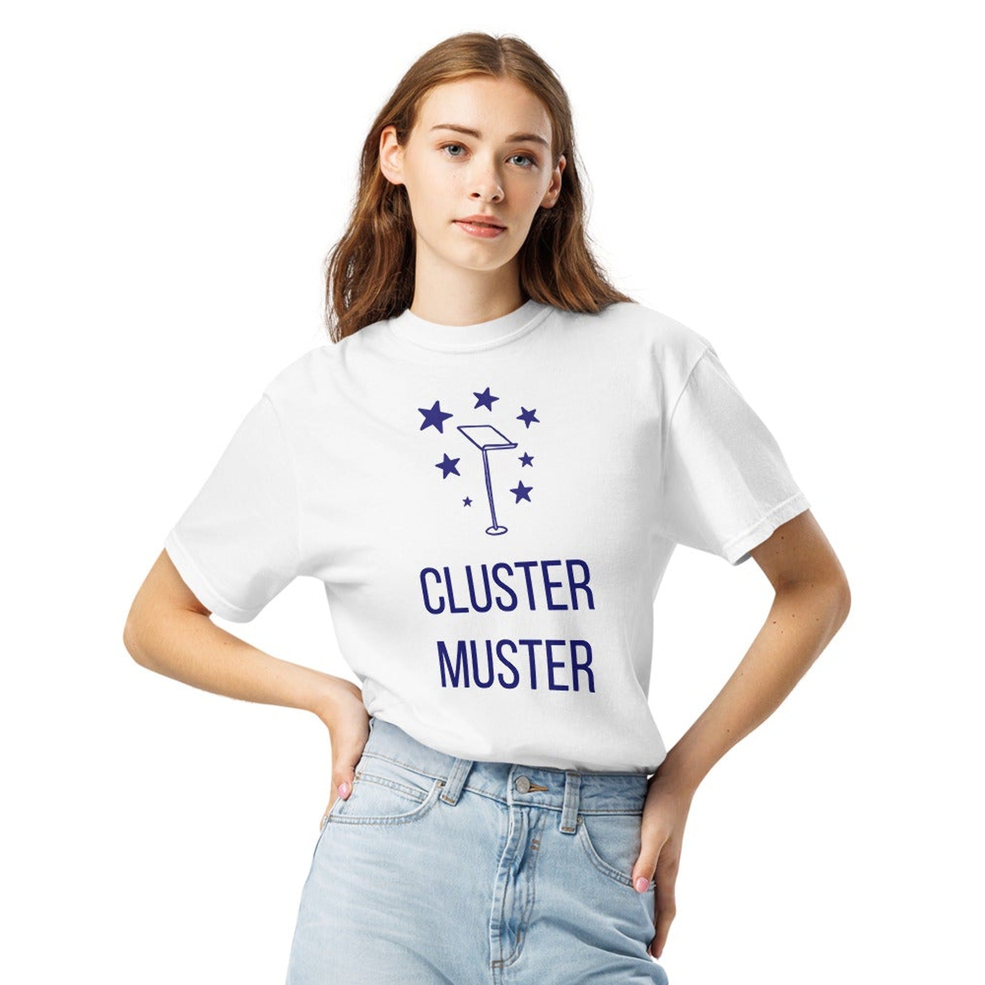 Woman wearing a White star cluster shirt printed with seven navy stars gathering around an empty conductor's music stand above the words CLUSTER MUSTER