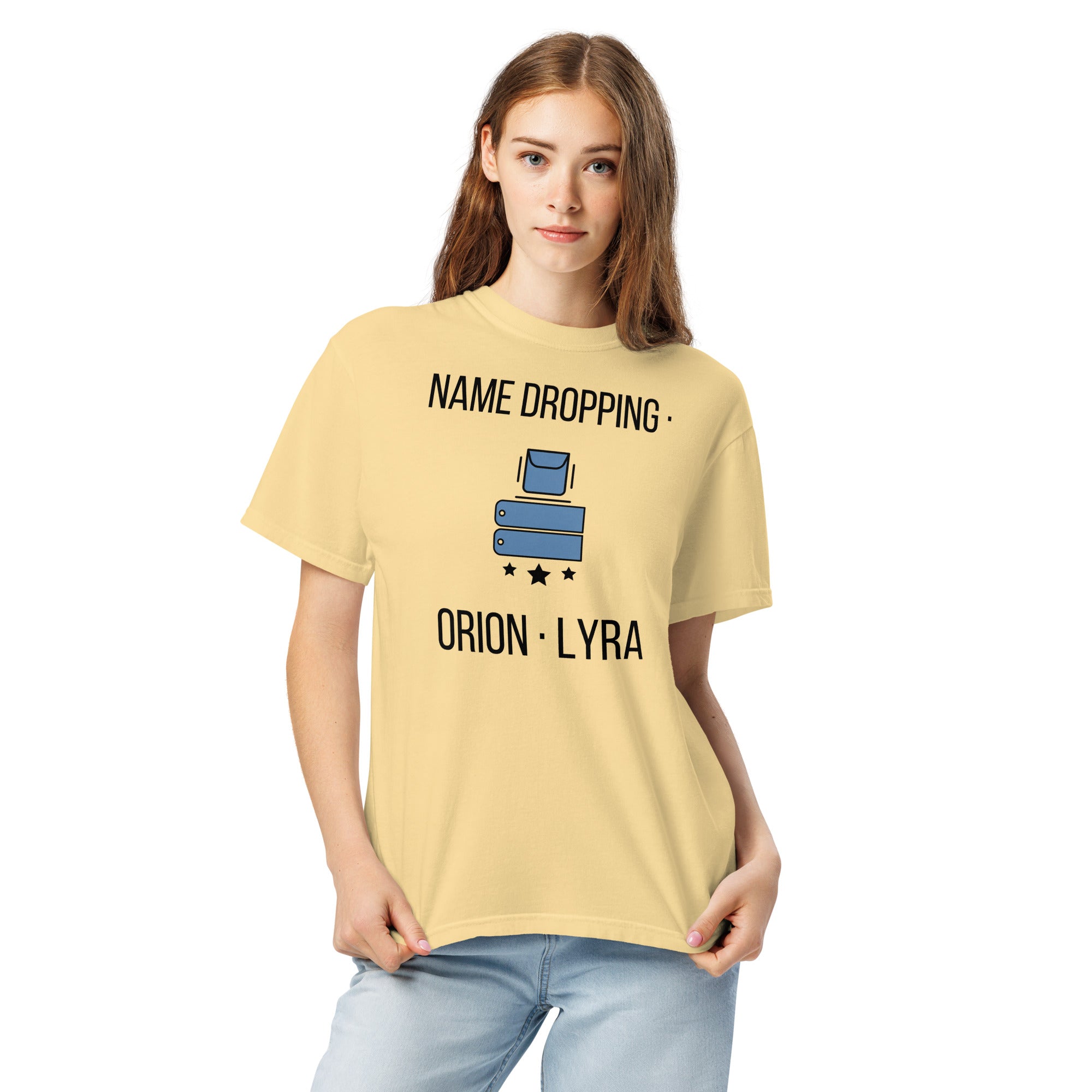 Woman wearing the Butter Name Dropping orion constellation shirt, front close-up with the pocket, name tags, stars and lettering fully visible