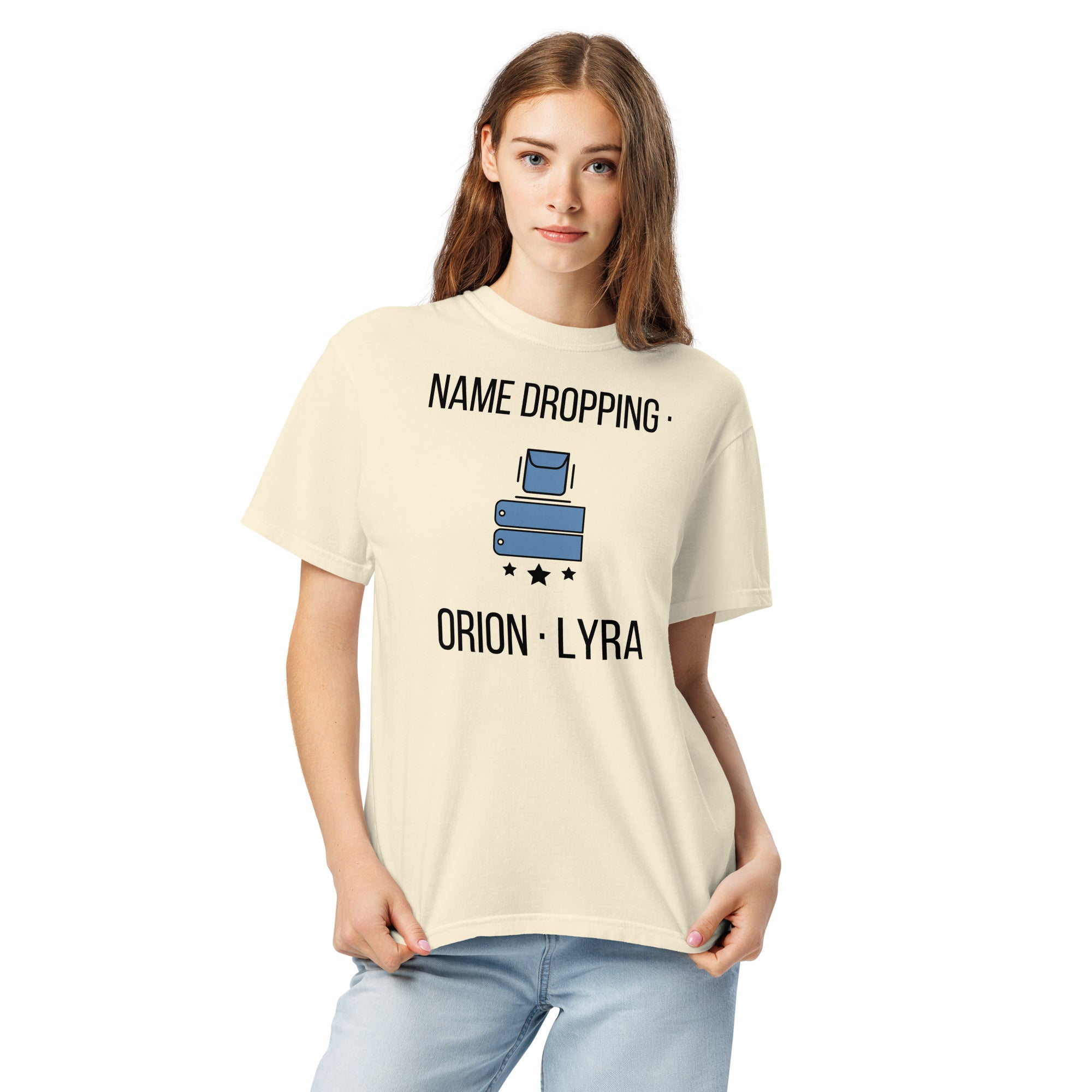 Woman wearing the Ivory Name Dropping orion constellation shirt, front close-up with the pocket, name tags, stars and lettering fully visible