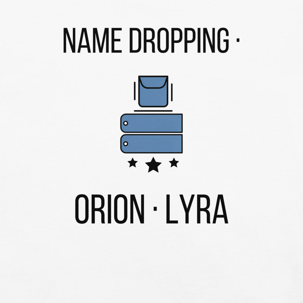 Close-up of the Name Dropping print on a White tee: a steel-blue pocket and two name tags above three black stars between NAME DROPPING and ORION · LYRA