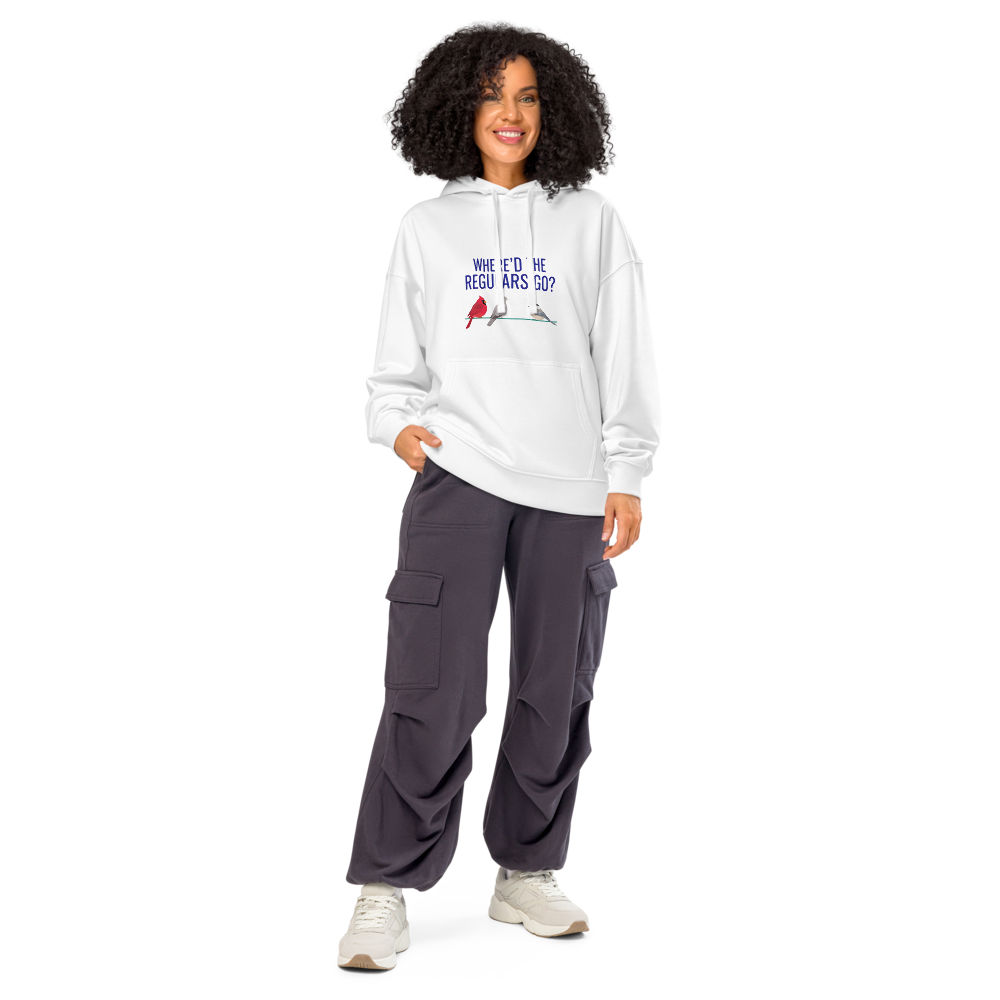 Woman wearing the white backyard bird hoodie with WHERE'D THE REGULARS GO? above three birds with a gap