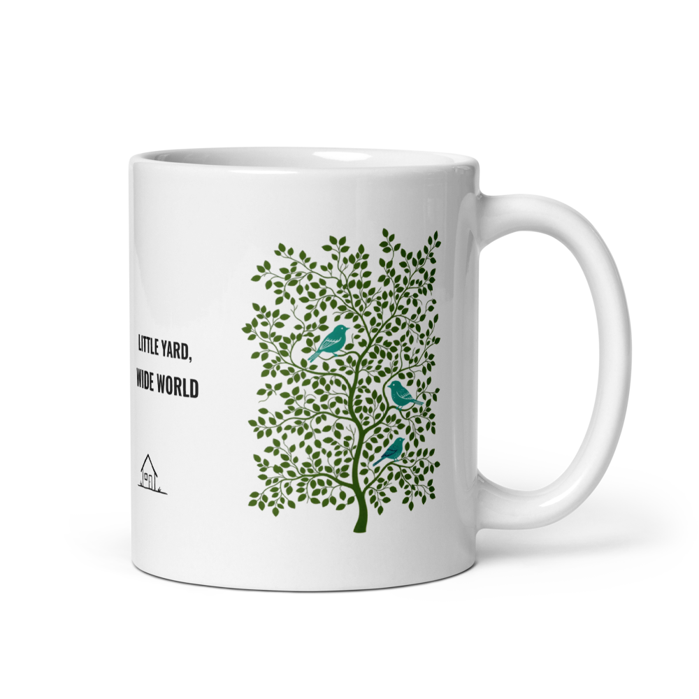 Backyard bird mug, 11 oz, handle on the right: LITTLE YARD, WIDE WORLD beside a leafy tree with three teal birds