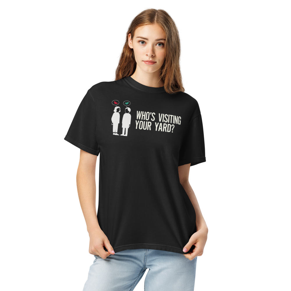 Close-up of a woman in the black backyard bird shirt, showing two neighbors with bird speech bubbles and WHO'S VISITING YOUR YARD?