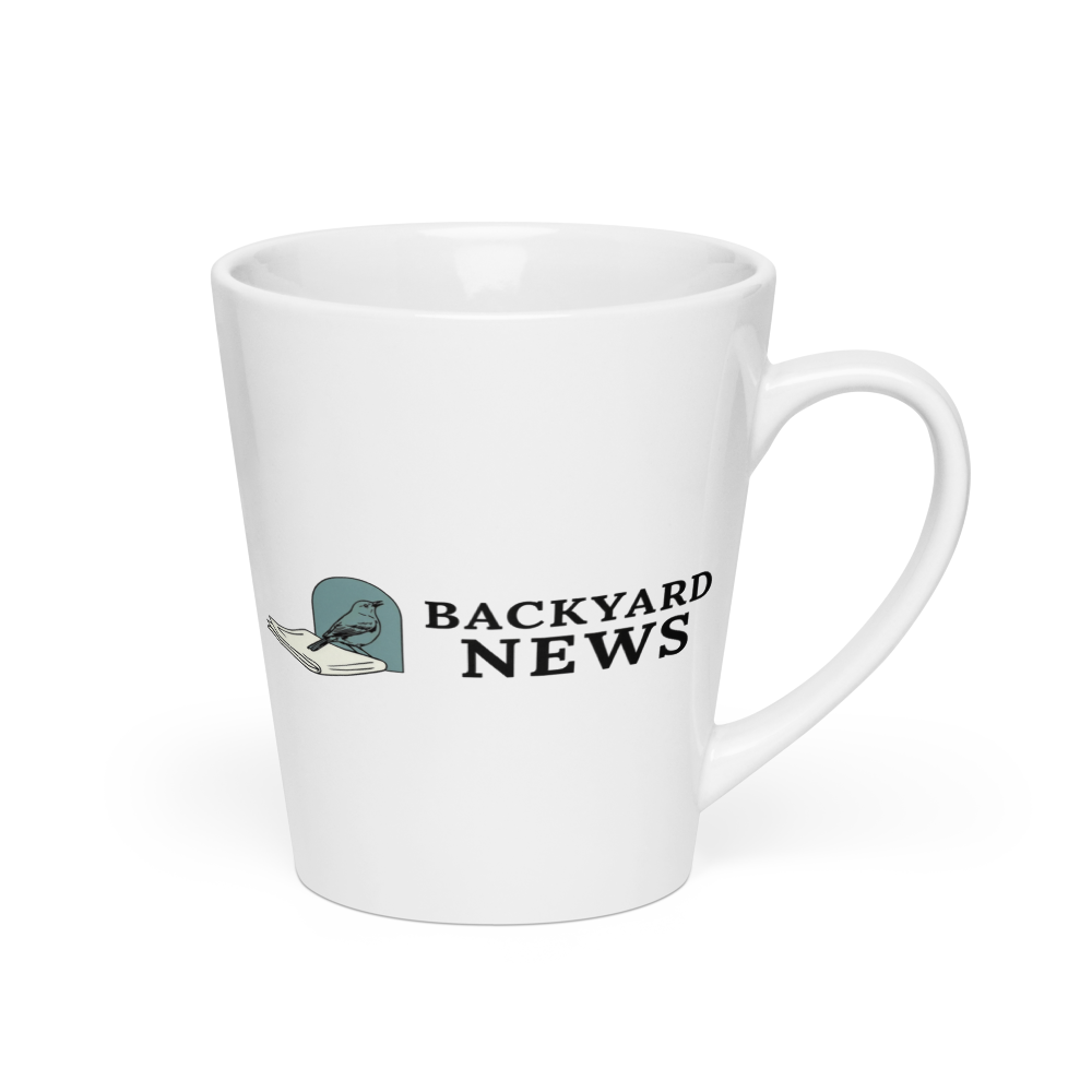 Bird coffee mug, 12 oz latte, handle on the right: a songbird on a folded newspaper beside BACKYARD NEWS