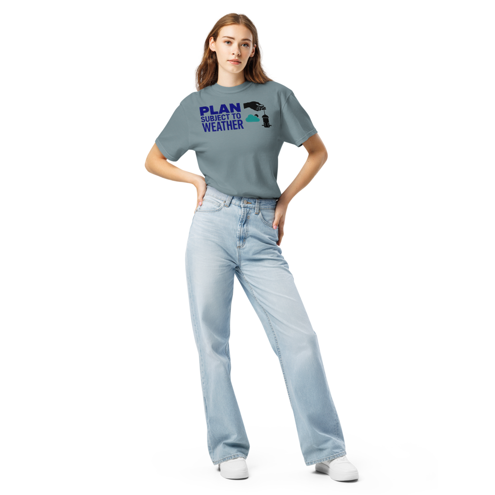 Woman wearing the Ice Blue bird feeder shirt with PLAN SUBJECT TO WEATHER beside a seed scoop, a cloud and a feeder
