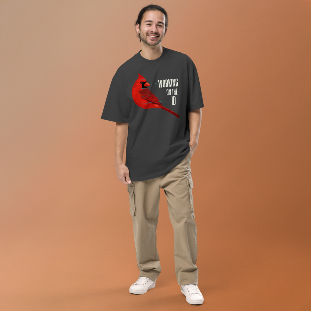Man in the faded black bird nerd shirt against a warm backdrop