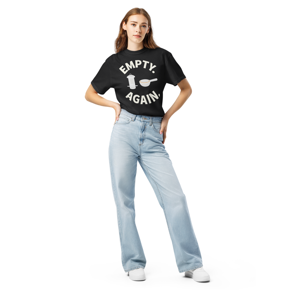 Woman wearing the black bird shirt for women with EMPTY. AGAIN. curved around a feeder and scoop