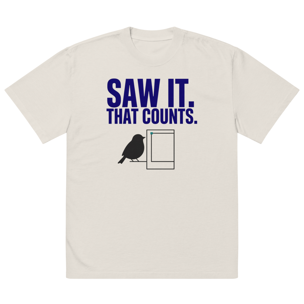 The faded bone bird shirt laid flat, showing SAW IT. THAT COUNTS. above a bird beside an empty photo frame