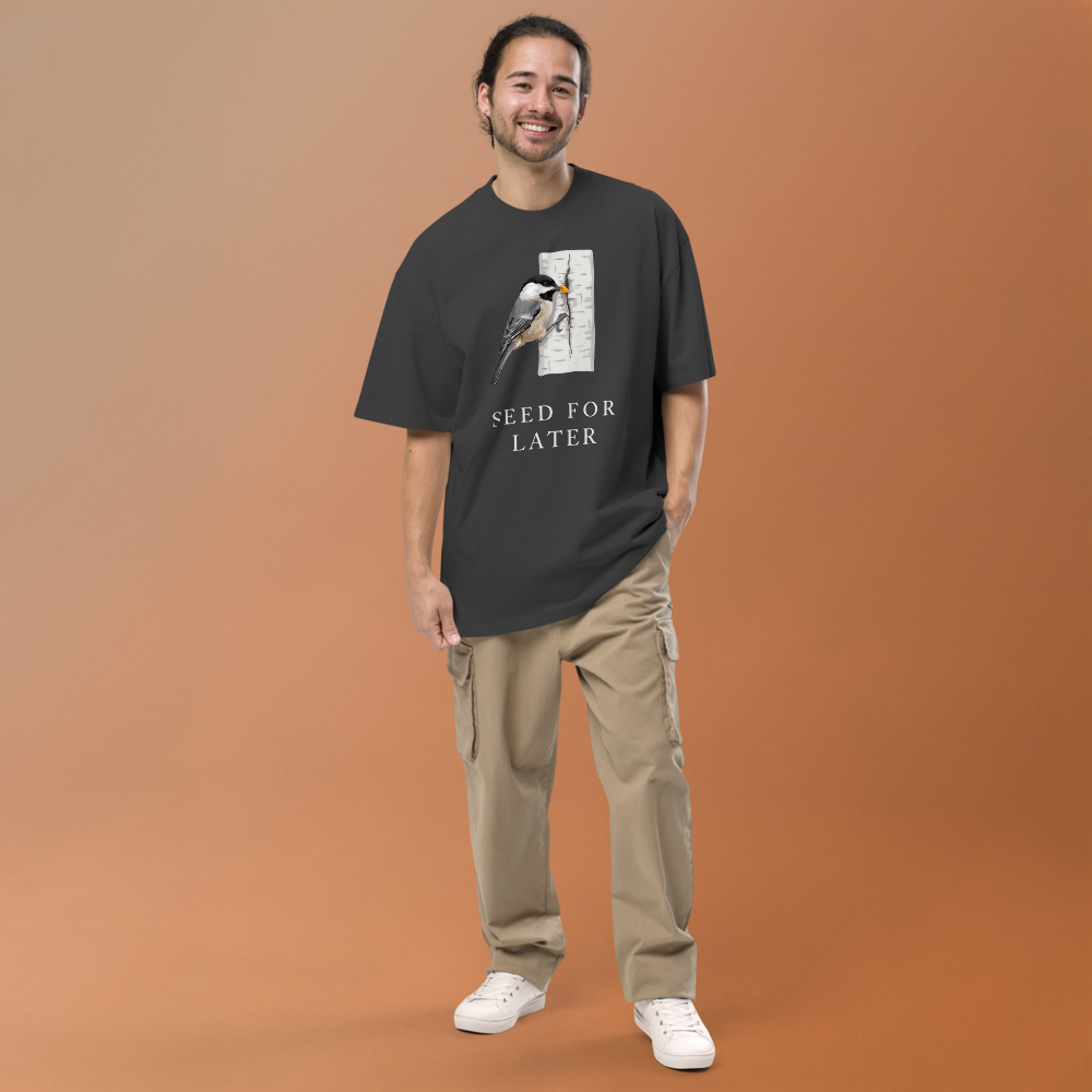 Man in the faded black bird t shirt against a warm backdrop