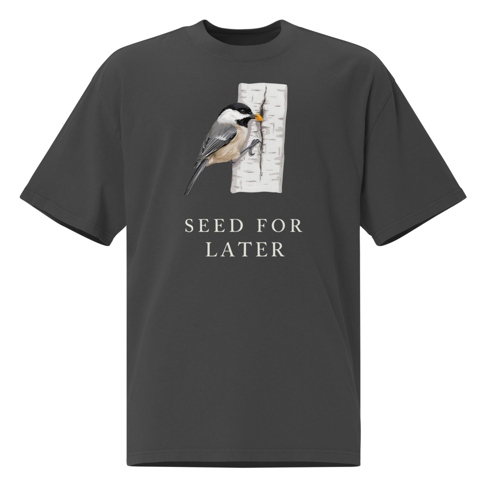 Bird T Shirt in Faded Black, front view: a chickadee tucking a seed into birch bark above SEED FOR LATER