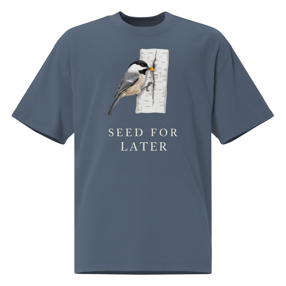 Bird T Shirt in Faded Indigo, front view: a chickadee tucking a seed into birch bark above SEED FOR LATER