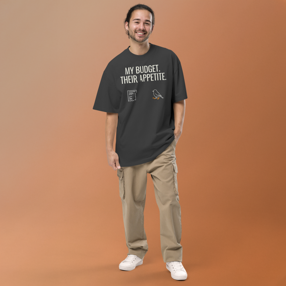 Man in the faded black bird watcher shirt against a warm backdrop