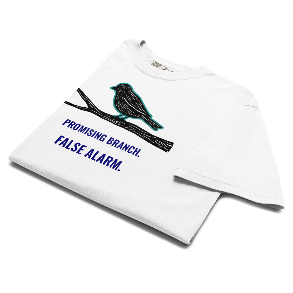 The white bird watching shirt folded, showing a bird-shaped branch above PROMISING BRANCH. FALSE ALARM.