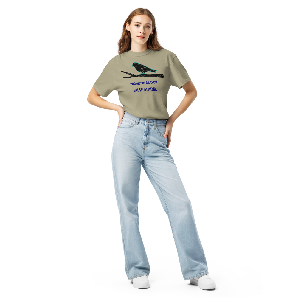 Woman wearing the Khaki bird watching shirt with a bird-shaped branch above PROMISING BRANCH. FALSE ALARM.