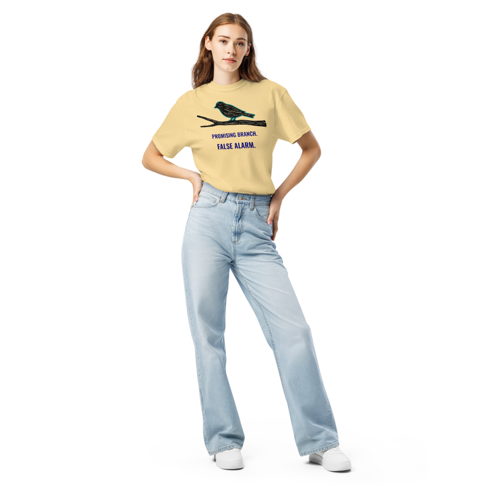 Woman wearing the Butter bird watching shirt with a bird-shaped branch above PROMISING BRANCH. FALSE ALARM.