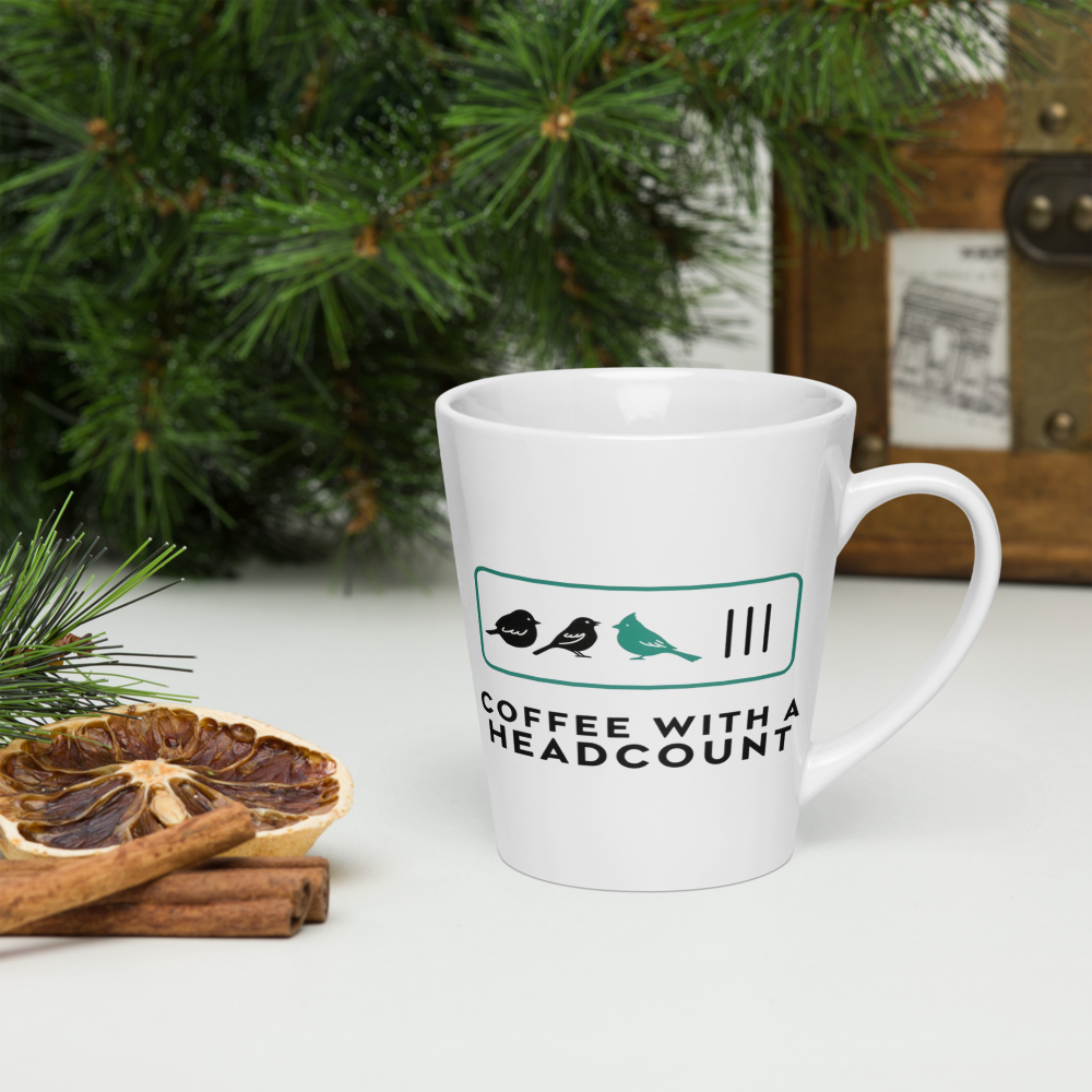 Birder gift mug on a table with pine branches, dried orange and cinnamon, showing three birds and three tally marks over COFFEE WITH A HEADCOUNT