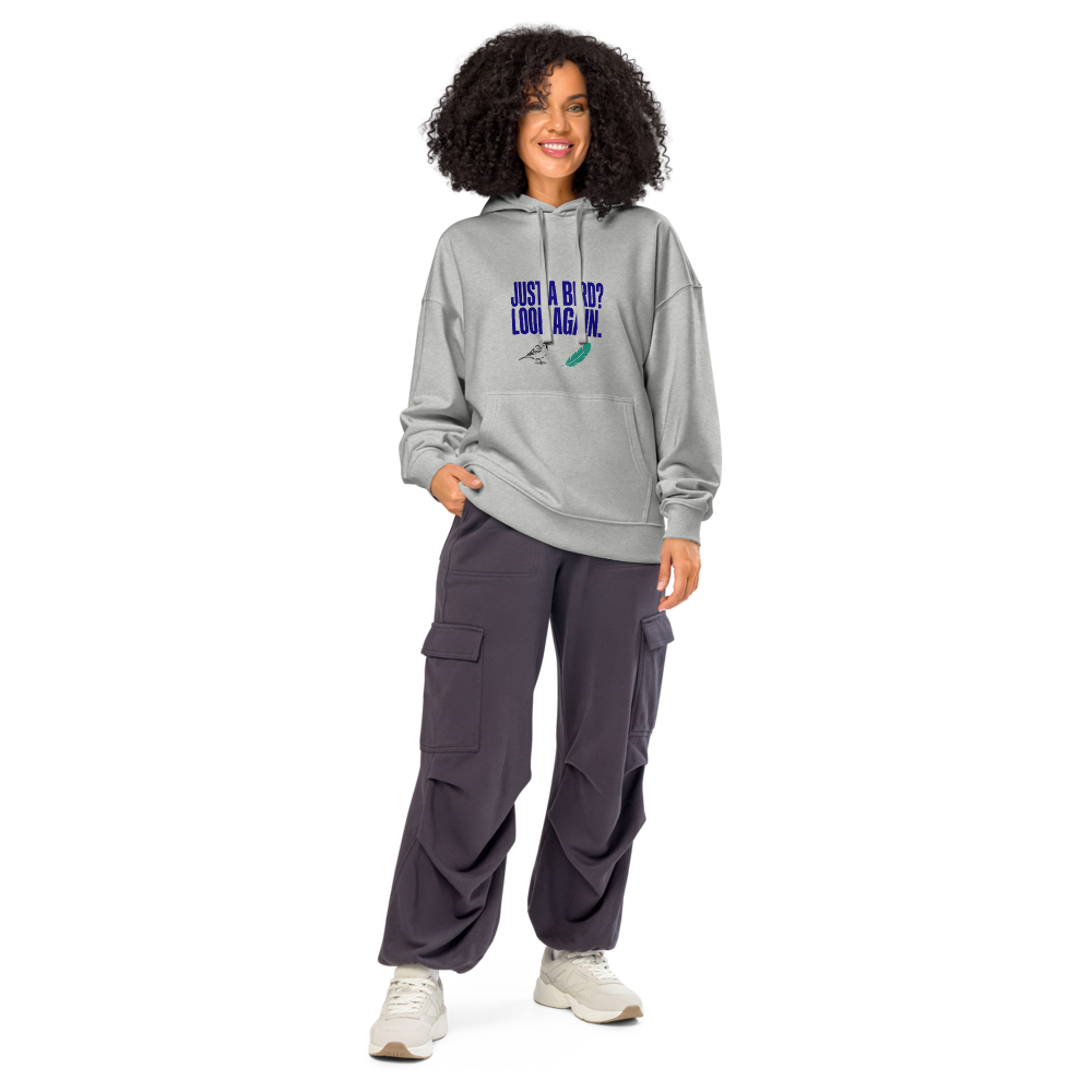 Woman wearing the Heather Grey birder hoodie with JUST A BIRD? LOOK AGAIN. above a sparrow and a feather