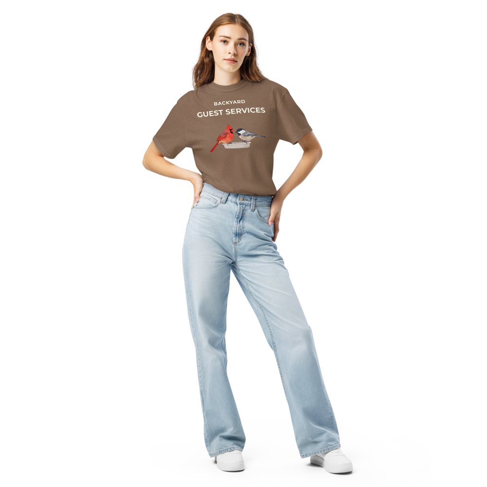 Woman wearing the Espresso cardinal shirt with BACKYARD GUEST SERVICES above a cardinal and a chickadee at a tray feeder