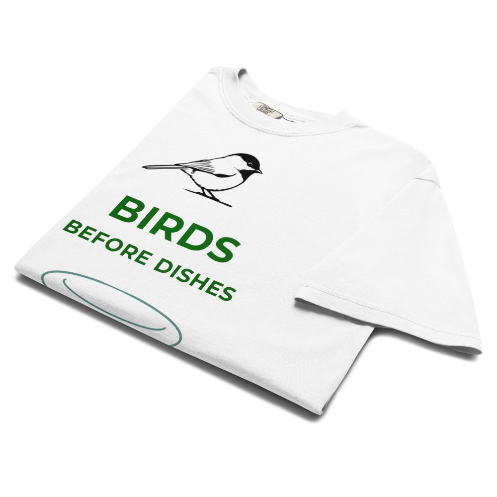 The white chickadee shirt folded, showing a chickadee above BIRDS BEFORE DISHES and a plate outline