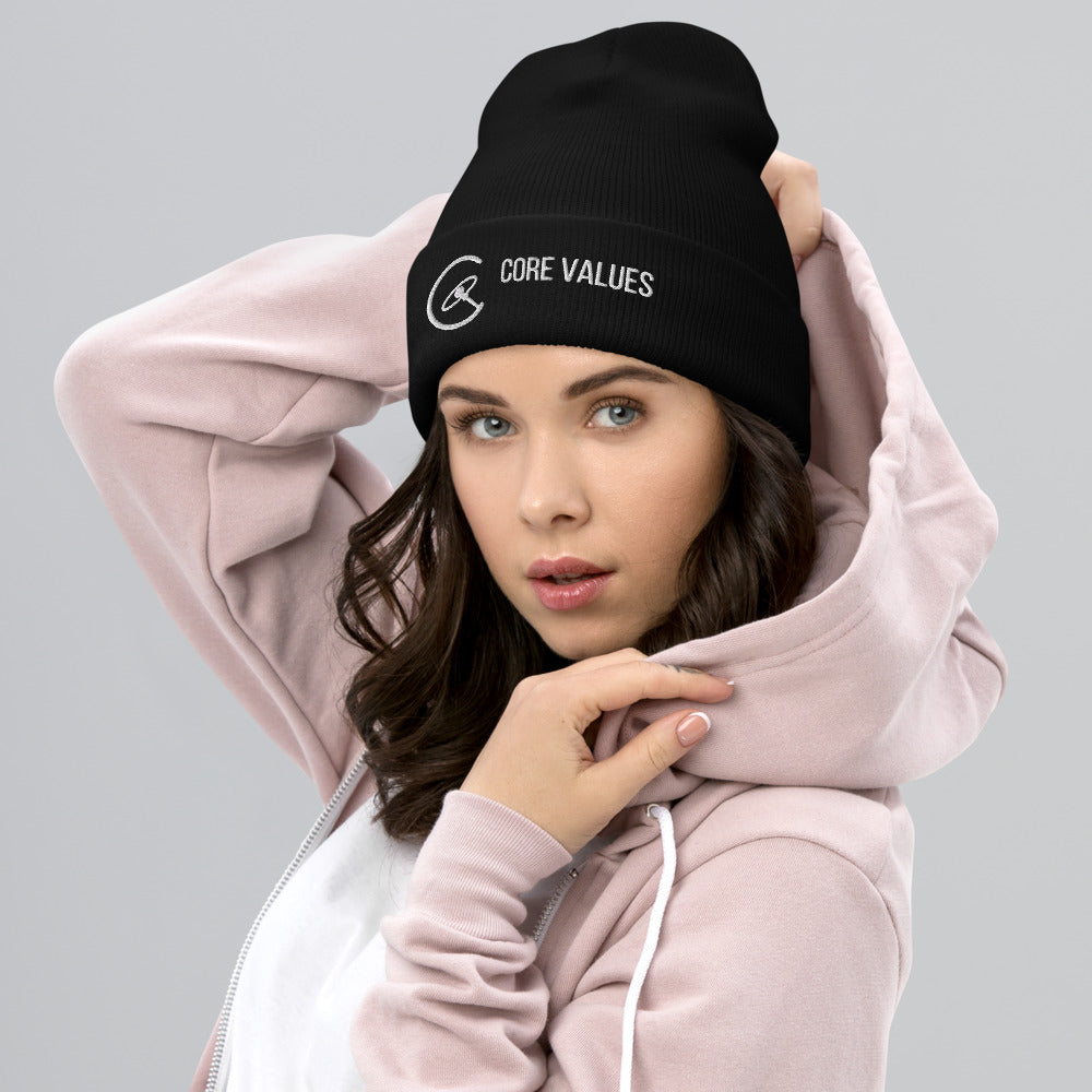 Woman in a pink hoodie wearing the black Core Values galaxy beanie, embroidered cuff facing forward