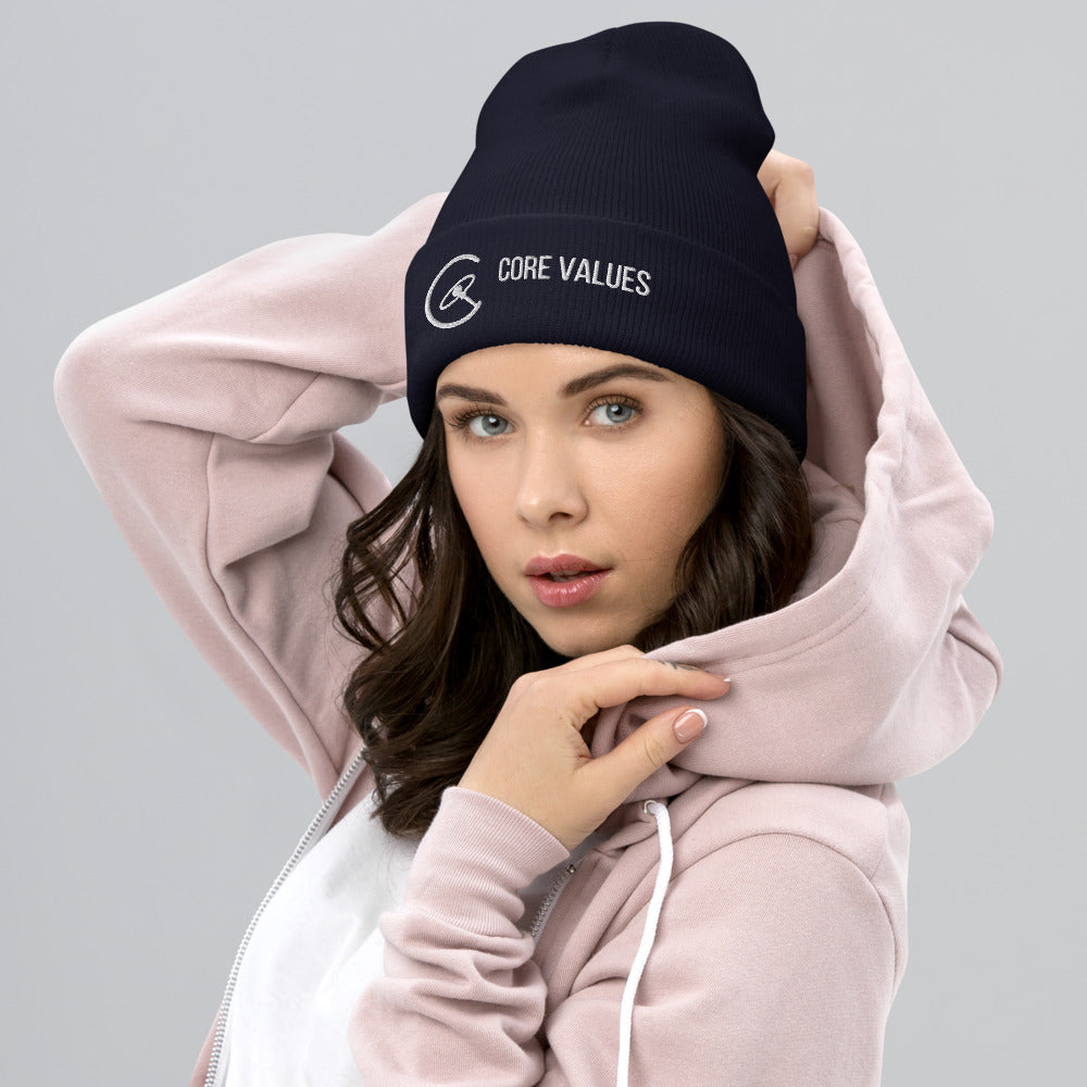 Woman in a pink hoodie wearing the navy Core Values galaxy beanie, embroidered cuff facing forward