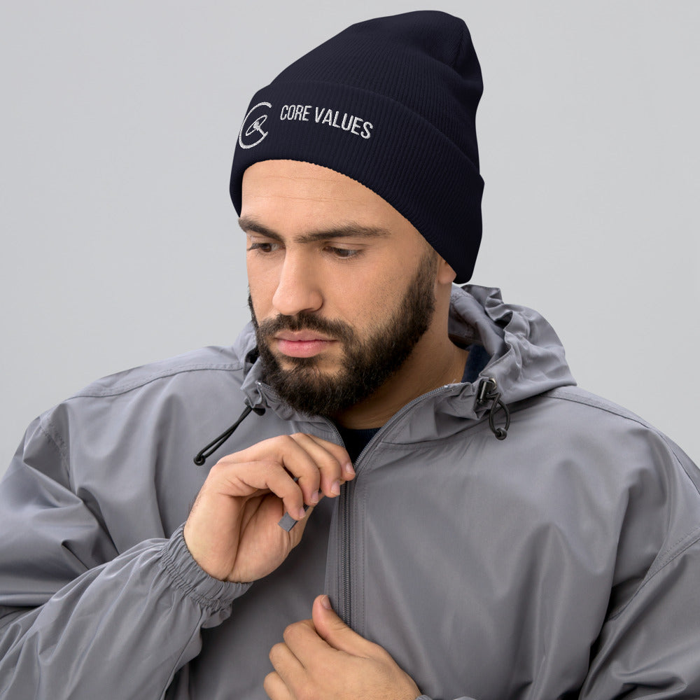 Bearded man in a gray jacket wearing the navy Core Values galaxy beanie with white embroidery on the cuff