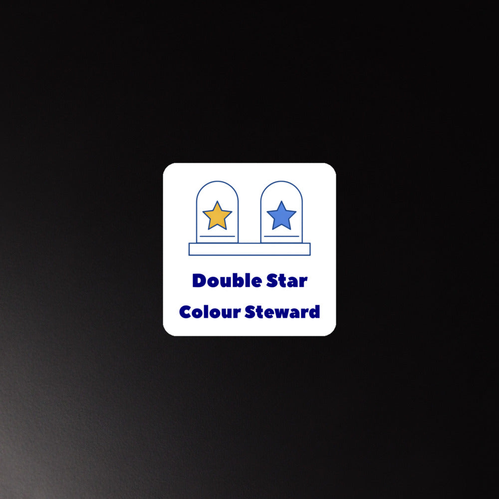 Double Star Colour Steward magnet on a dark metal surface, white square with rounded corners