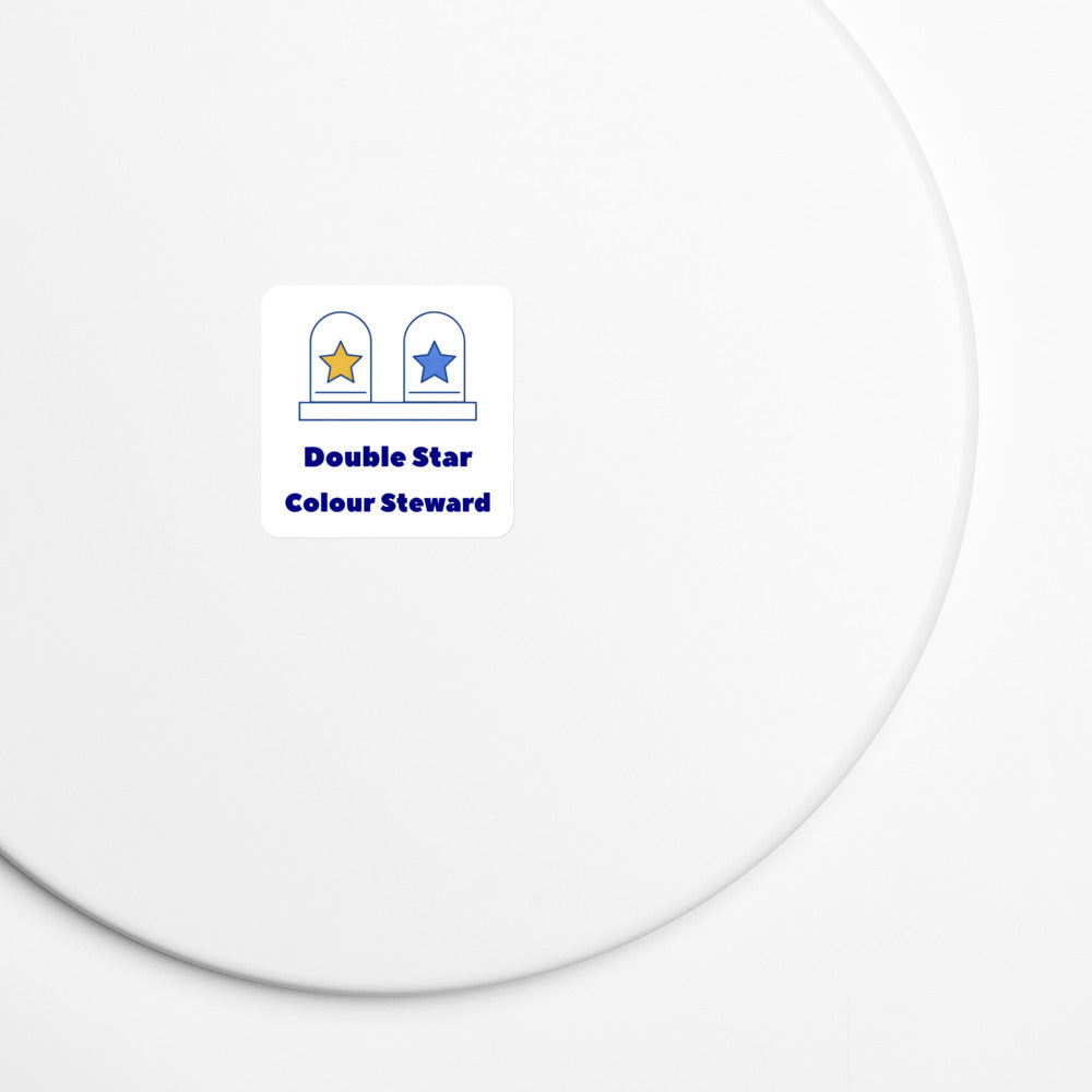 Double Star Colour Steward magnet on a white metal board