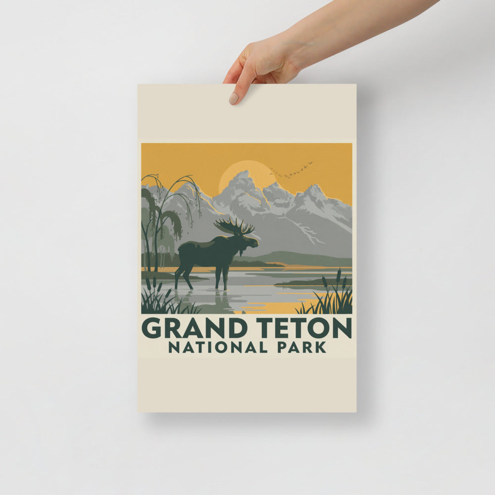 Grand Teton National Park vintage poster held flat against a plain grey wall