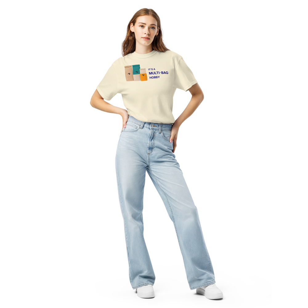 Woman wearing the Ivory funny bird shirt with three seed bags beside IT'S A MULTI-BAG HOBBY