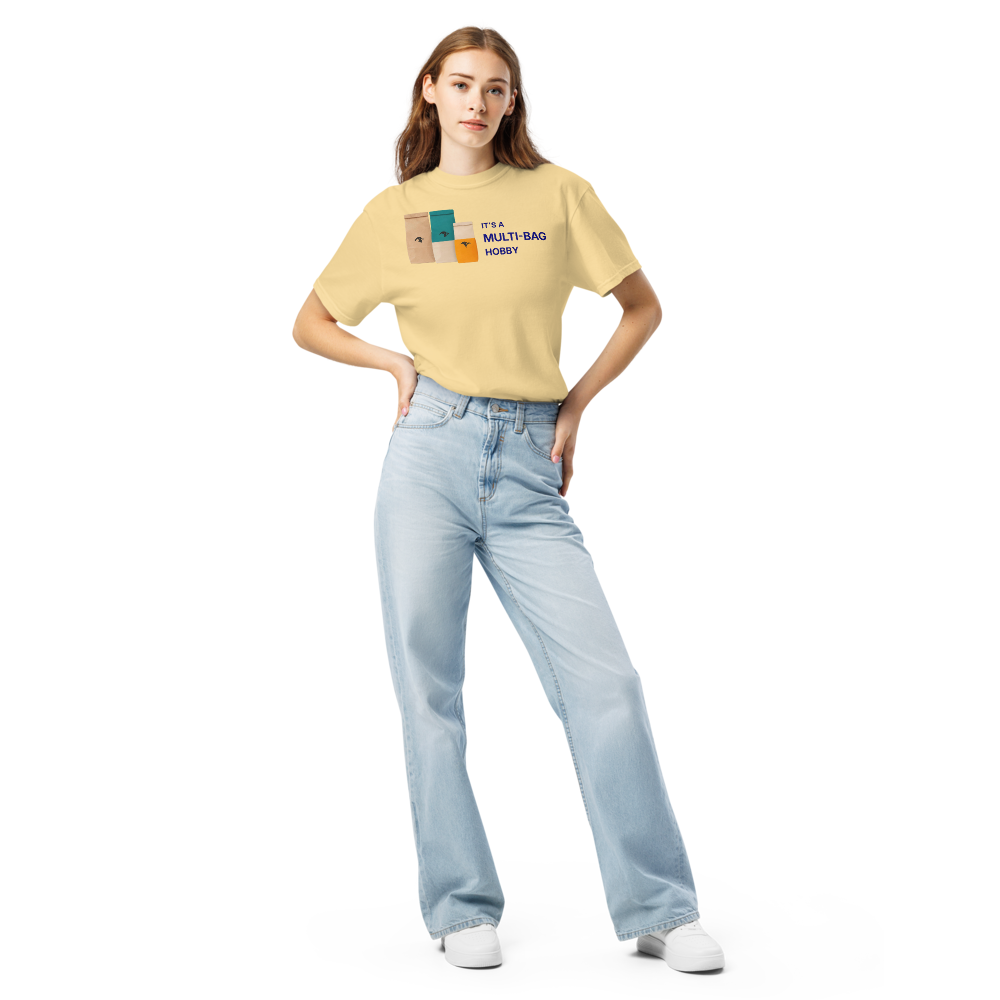 Woman wearing the Butter funny bird shirt with three seed bags beside IT'S A MULTI-BAG HOBBY