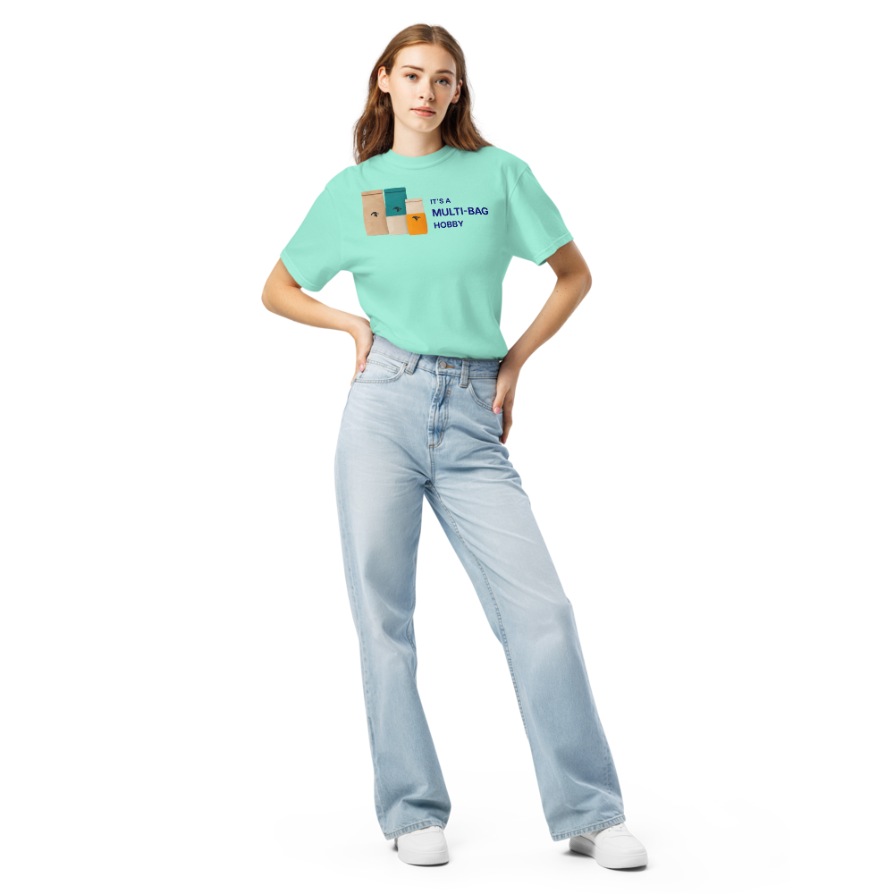 Woman wearing the Chalky Mint funny bird shirt with three seed bags beside IT'S A MULTI-BAG HOBBY