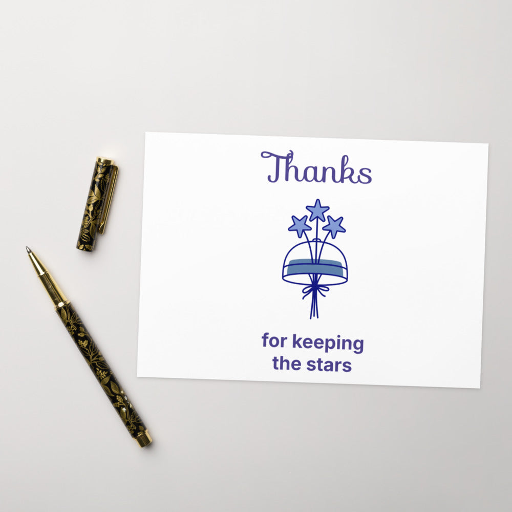 5x7 in Thanks for keeping the stars card for a dark sky volunteer, set on a soft gray surface with a gold pen