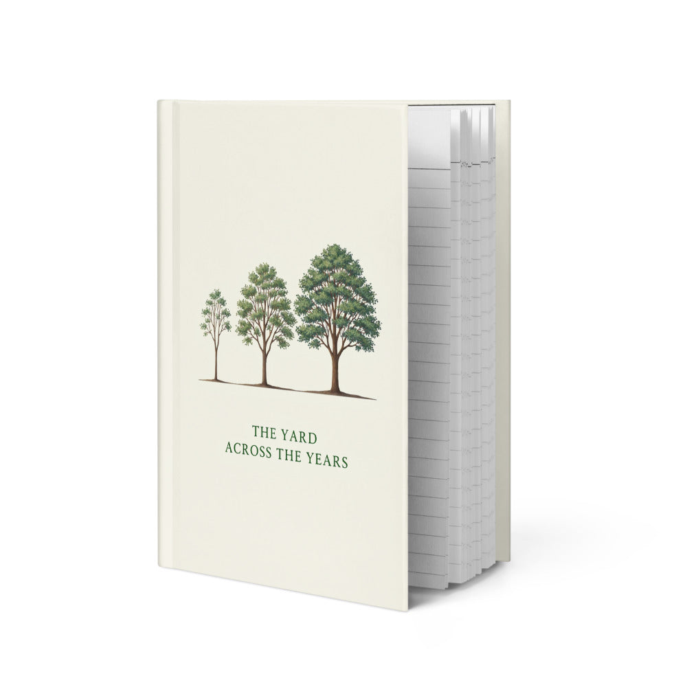 Nature journal standing at an angle, showing the three-tree design on the ivory hardcover and the edge of the lined pages