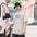 Man in a bucket hat wearing a Faded Bone messier shirt printed with a speech bubble reading ASK ME ABOUT MY M74 and a long zigzag tail ending at a small spiral galaxy