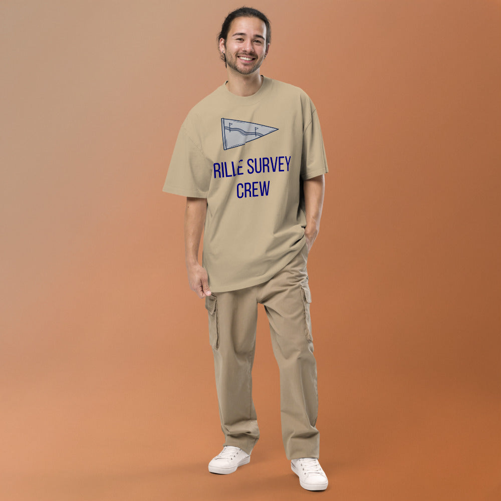 Man wearing the Faded Khaki Rille Survey Crew moon shirt against a warm studio backdrop, front view of the lunar pennant print