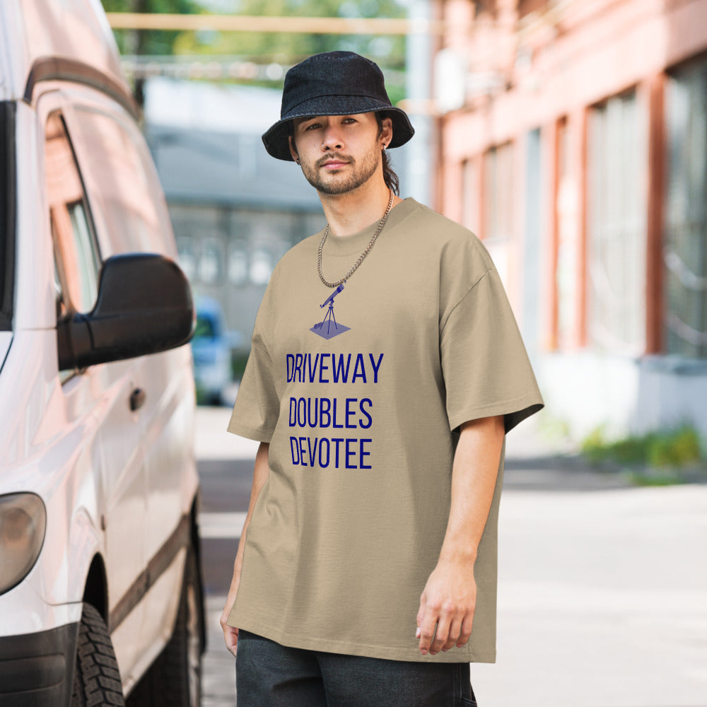 Man in a bucket hat wearing the Faded Khaki telescope shirt beside a parked van, small telescope on a tripod above the words DRIVEWAY DOUBLES DEVOTEE