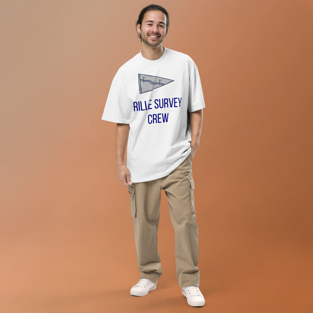 Man wearing the Faded White Rille Survey Crew moon shirt against a warm studio backdrop, front view of the lunar pennant print