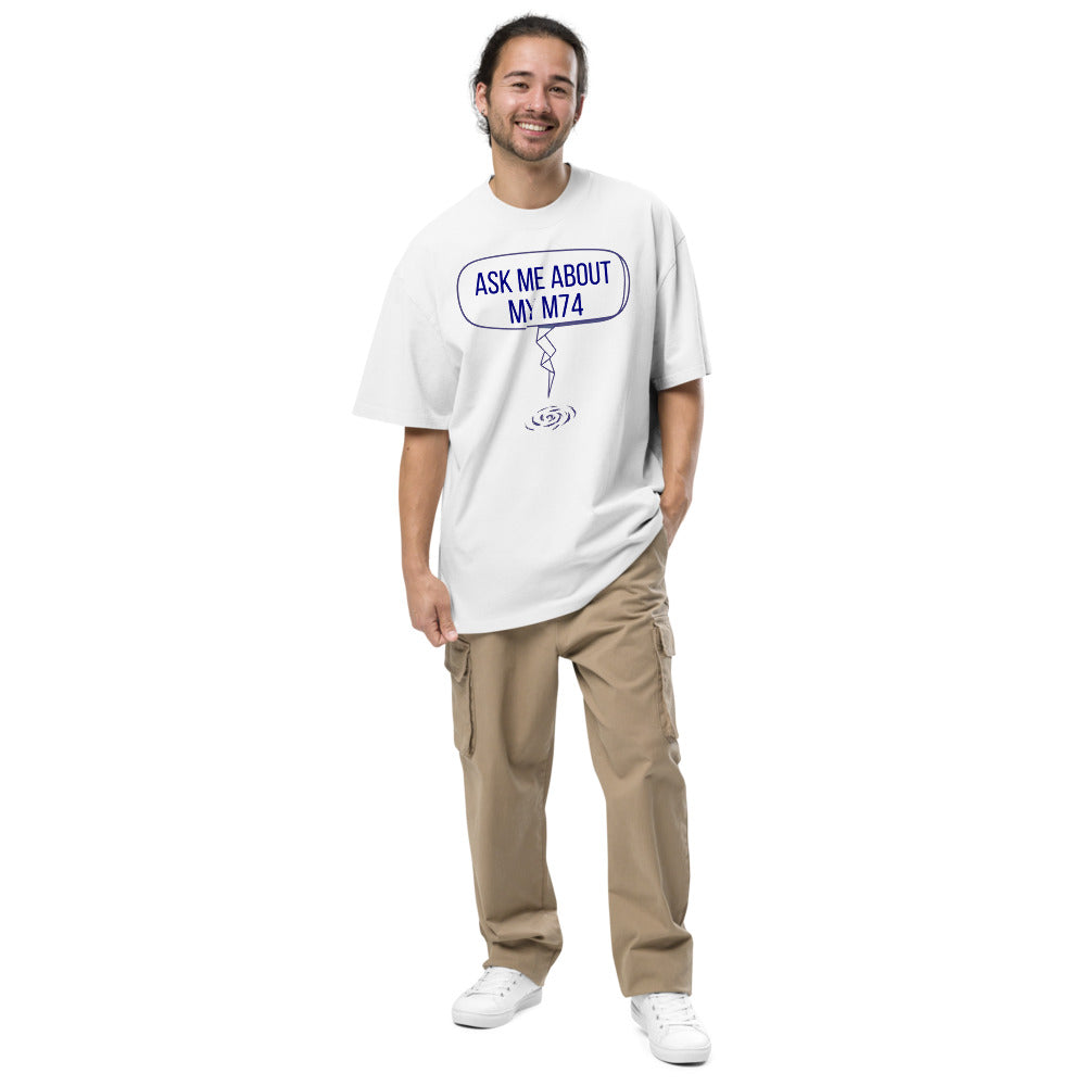 Smiling man wearing the Faded White Ask Me About My M74 oversized tee, full front view