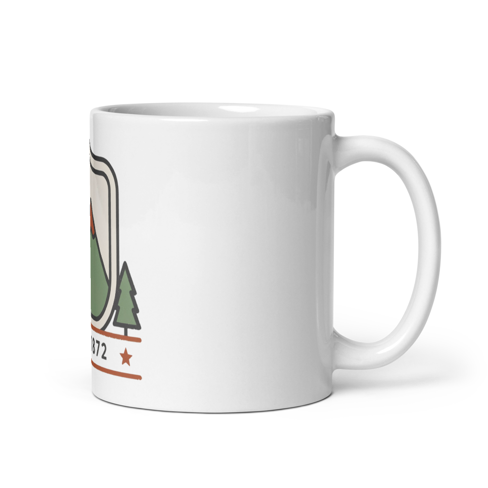 Est. 1872 national park badge mug shown with the handle on the right in forest green, rust and charcoal