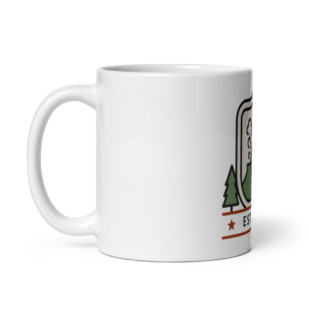 Est. 1872 national park badge mug shown with the handle on the left so the artwork faces out for left-handed users