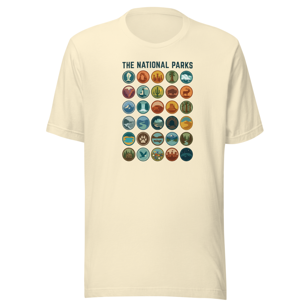 Natural cream unisex t-shirt printed with thirty vintage national park badges in a five by six grid under the headline The National Parks