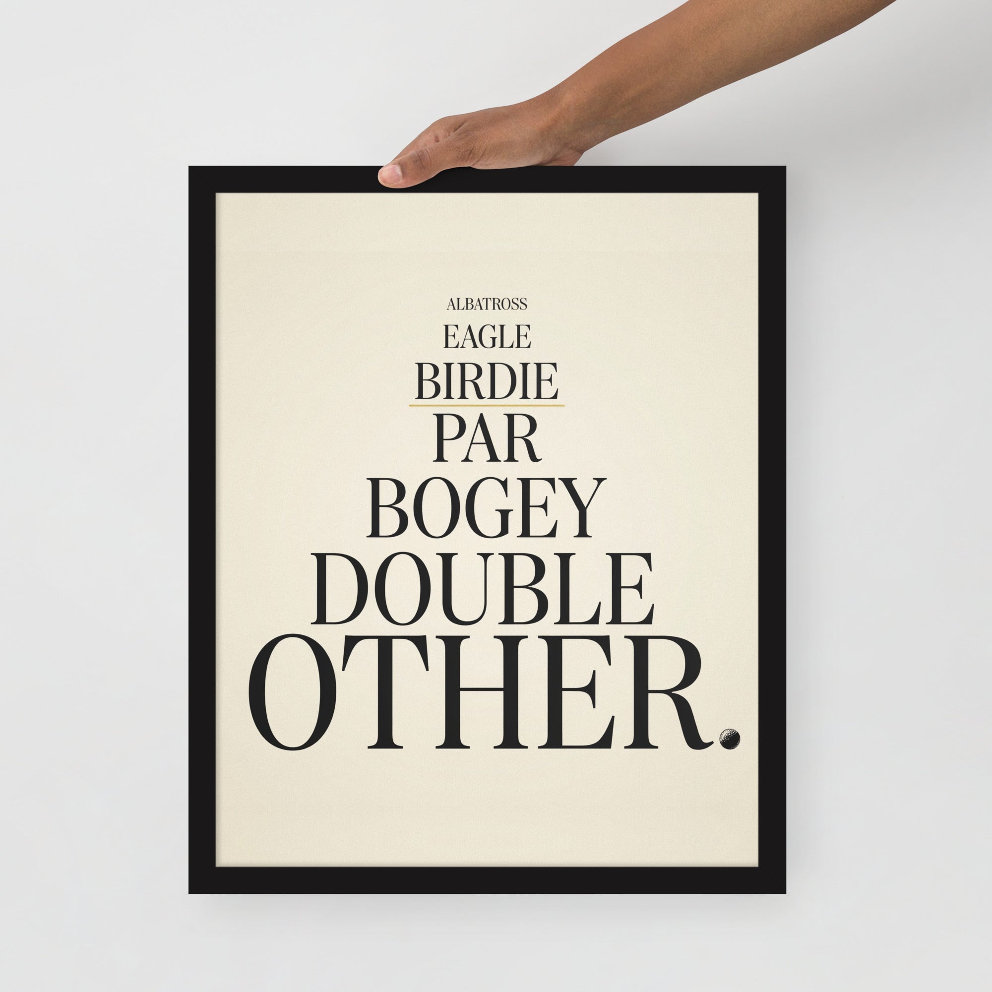 16″×20″ framed golf print held by its top edge against a gray wall: seven scoring words in black serif capitals