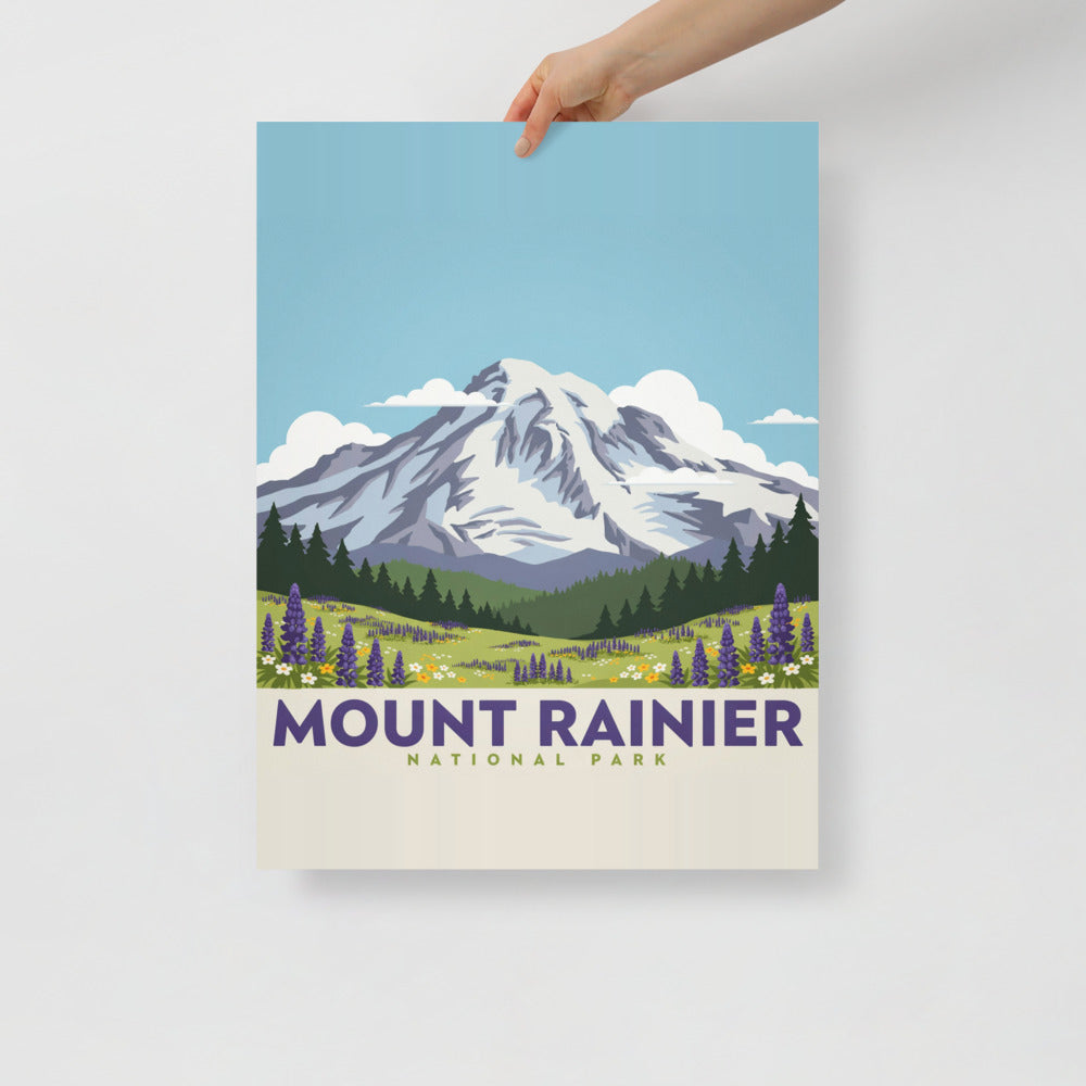 Hand holding the Mount Rainier National Park vintage poster against a plain wall