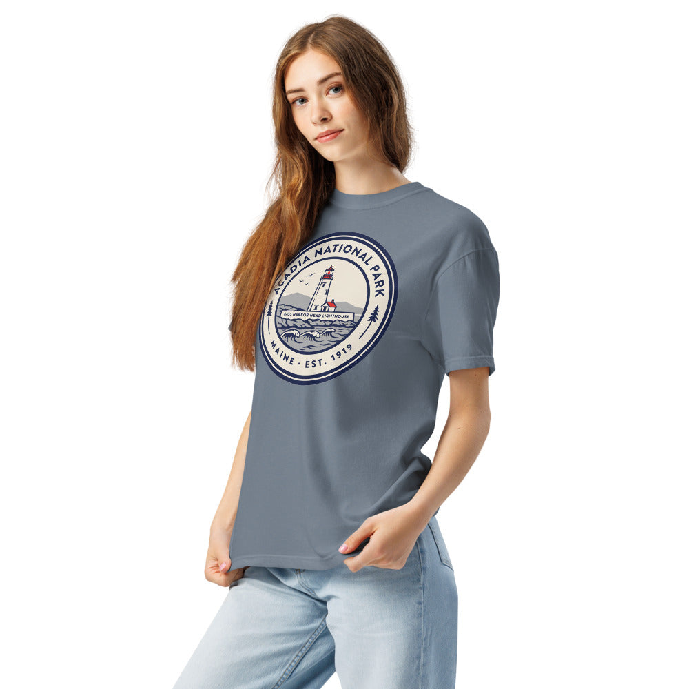 Acadia National Park vintage lighthouse badge t-shirt in blue jean worn by a model, left-front angle