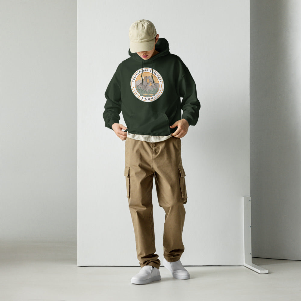 Yosemite National Park vintage Half Dome sunrise badge hoodie in forest green worn by a man, front view
