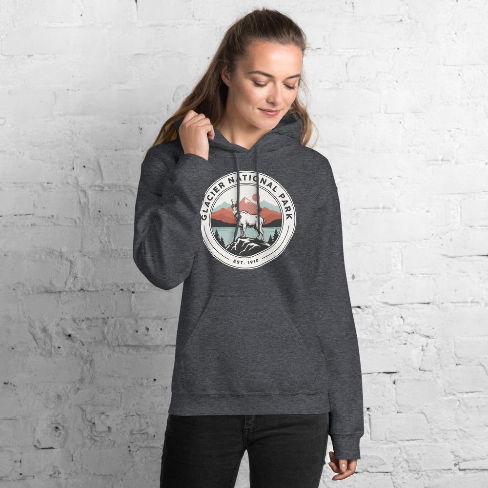Glacier National Park vintage mountain goat badge hoodie in dark heather grey worn by a woman, front view