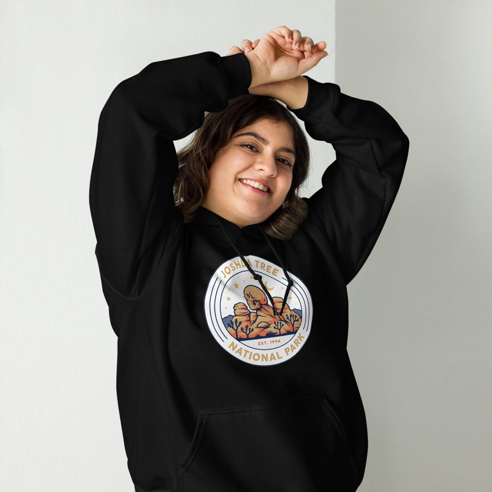 Joshua Tree National Park vintage desert boulders and stars badge hoodie in black worn by a woman, front view