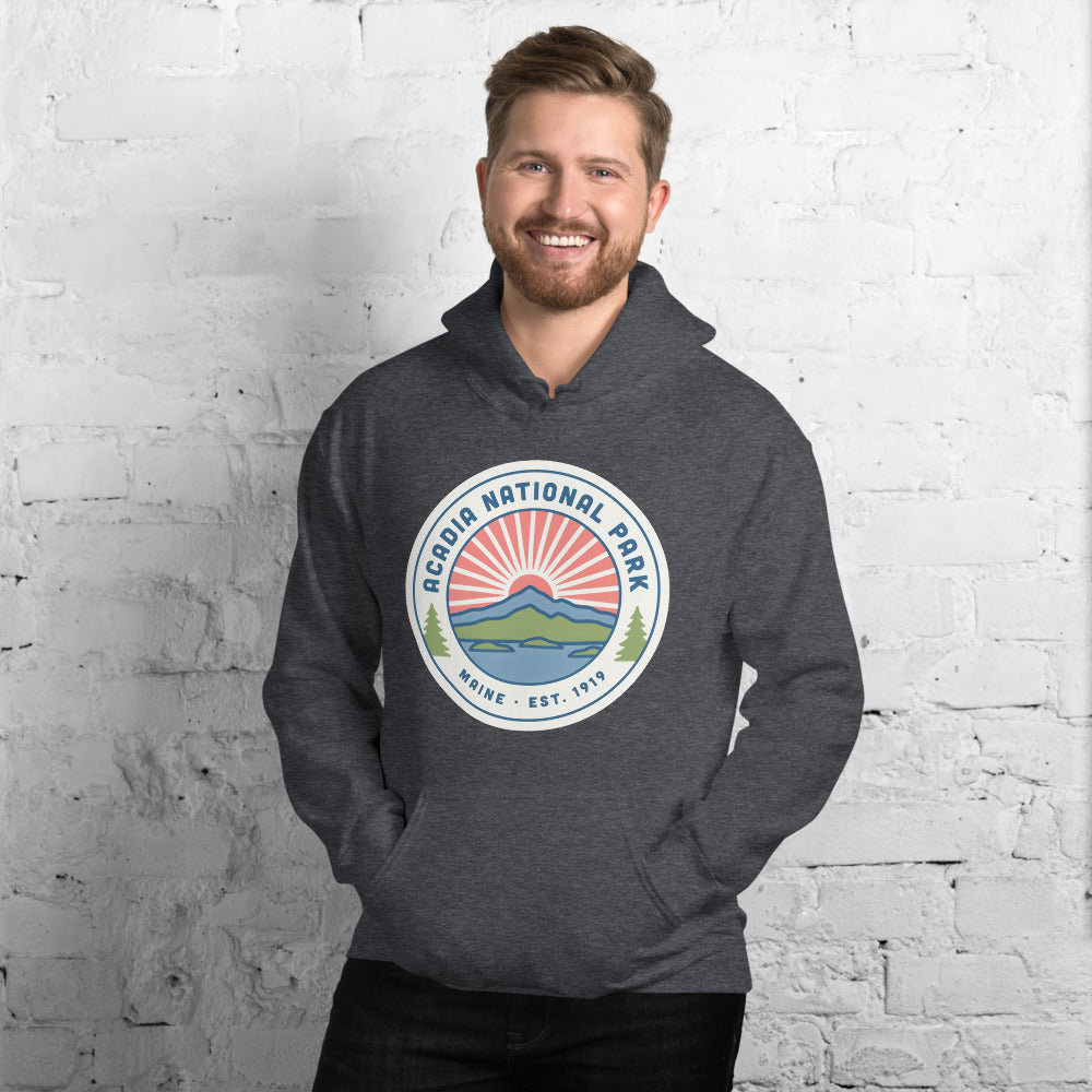 Acadia National Park vintage coastal sunrise badge hoodie in dark heather grey worn by a man, front view